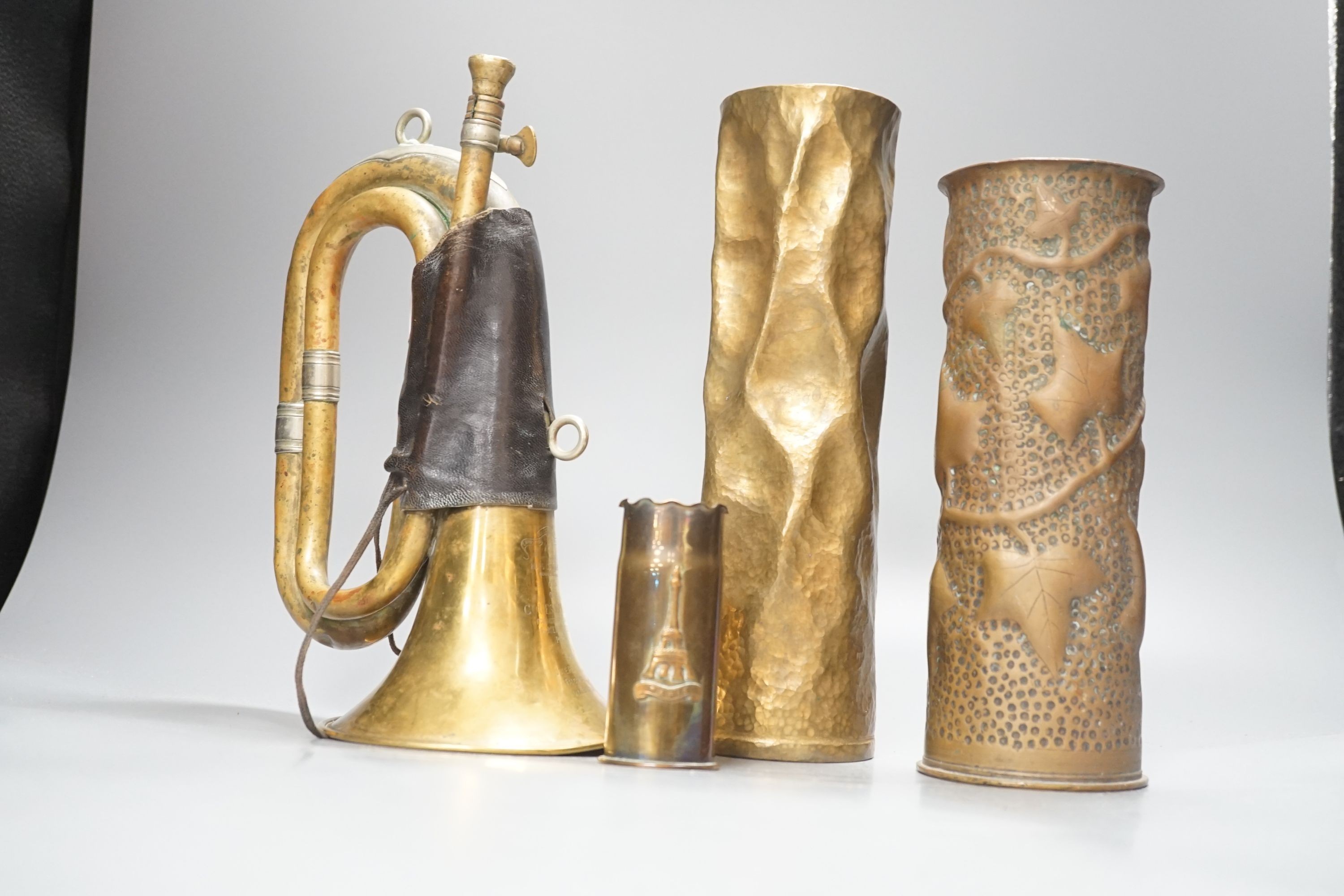 Three WWI brass trench art shell cases and a Couesnon & Cie brass bugle